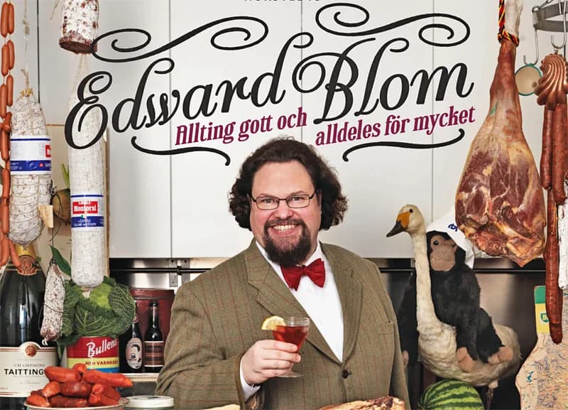 Omslaget till kokboken Allting gott och alldeles för mycket, Edward Blom med drink i handen omgiven av charkuterier